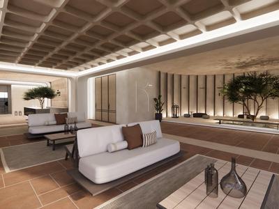 Salón moderno con sofás, mesa y luz indirecta en un patio de hotel.