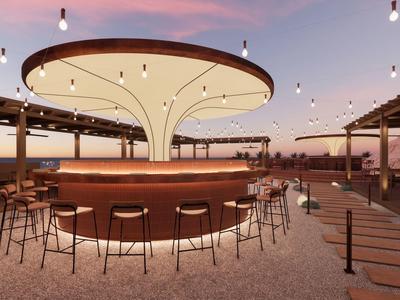 Barra exterior moderna con asientos circulares y techo iluminado al atardecer