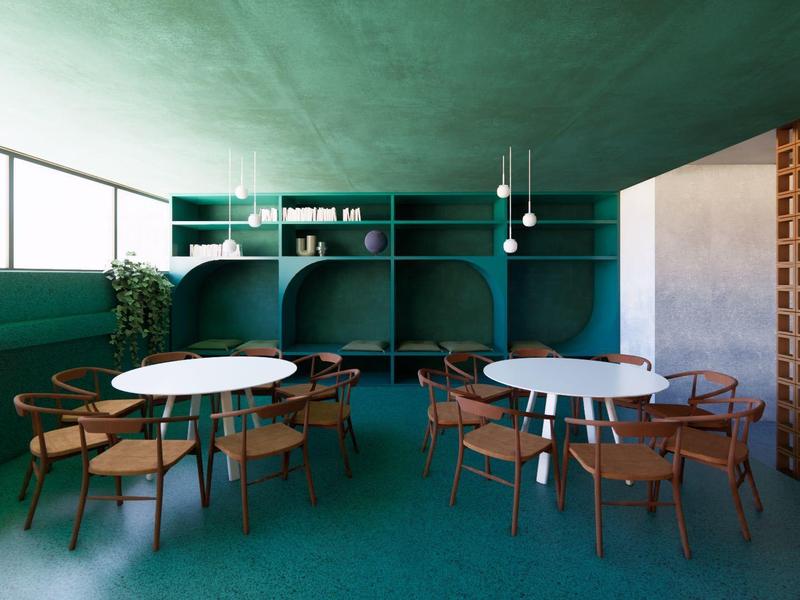 Comedor moderno verde con mesas redondas y sillas de madera, iluminado por grandes ventanas.