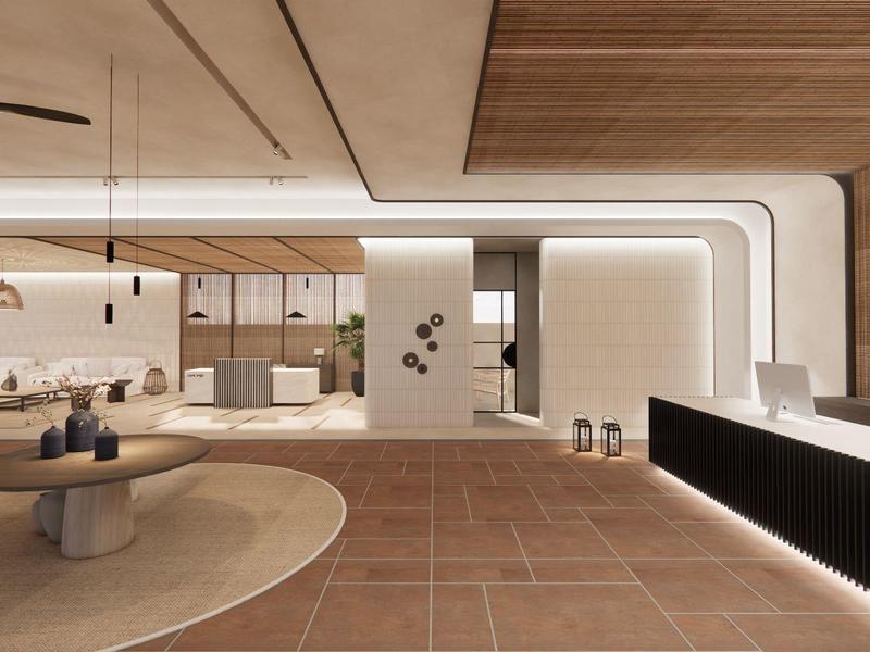 Área de recepción moderna con alfombra redonda, asientos y mostrador iluminado.