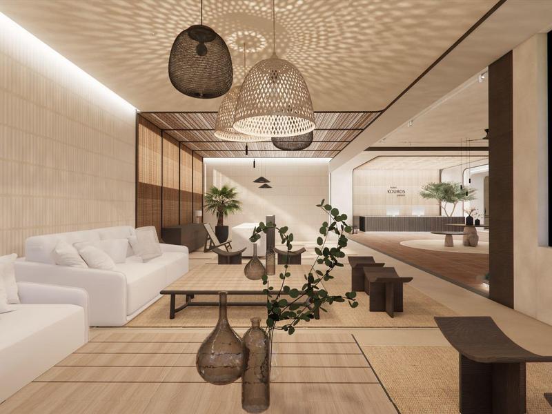 Sala de estar moderna y luminosa con sofás blancos y plantas decorativas sobre suelo de madera.