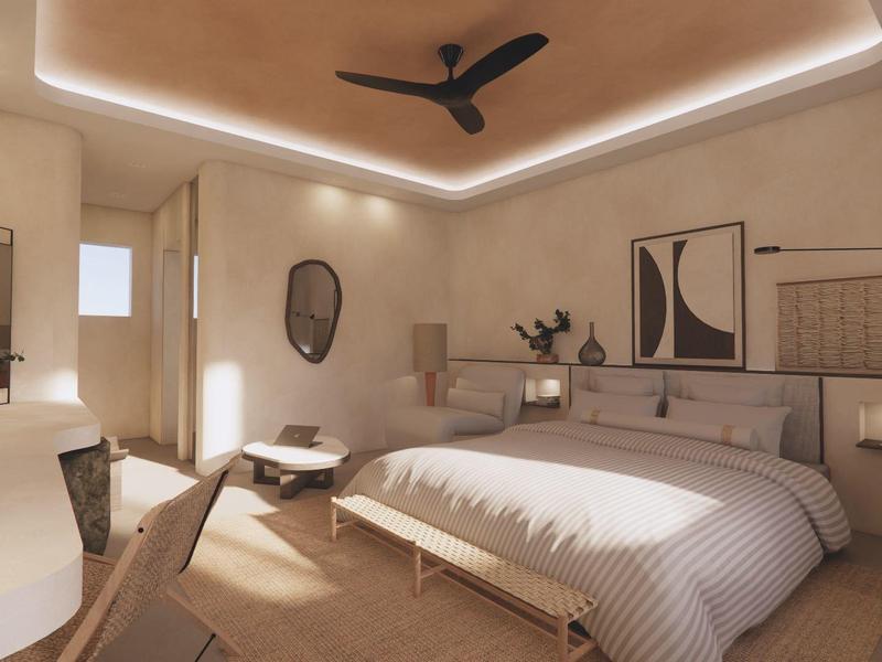 Habitación de hotel luminosa con cama grande, escritorio, espejo y ventilador de techo.