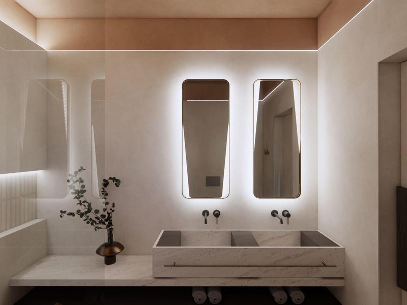 Baño moderno con lavabo doble y espejos iluminados en tonos neutros.