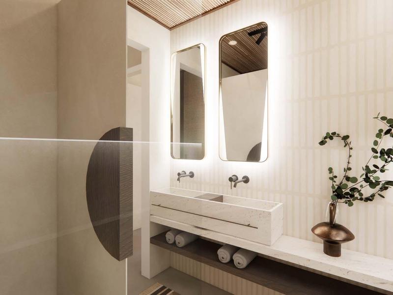 Baño moderno y luminoso con espejo grande, lavabo y plantas en una repisa.