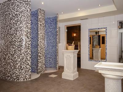 Moderne Lobby mit grauem Teppich, weiß-blau gemusterten Säulen und weißen Sockeln.