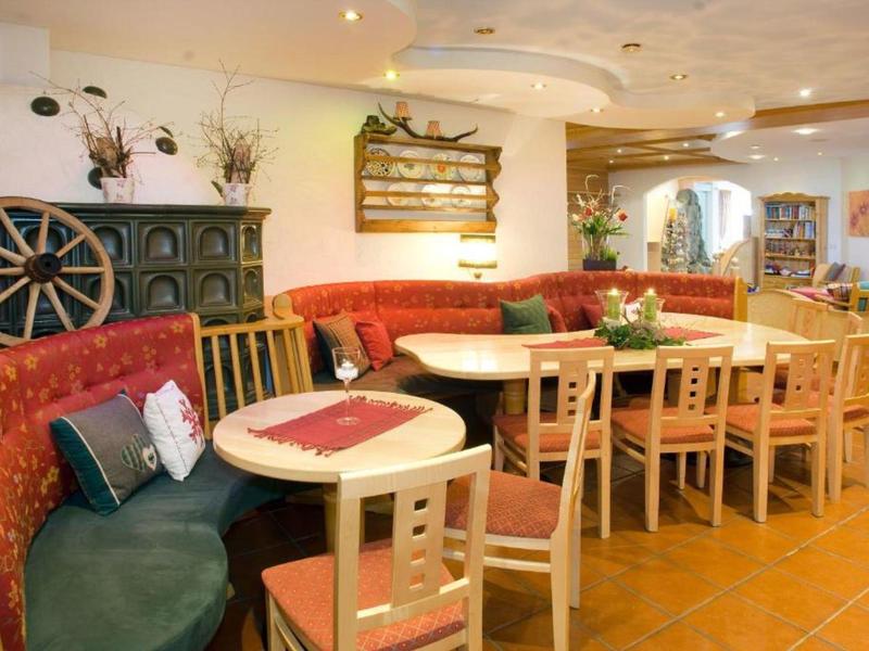 Cozy hotel lounge with colorful benches and wooden tables in warm light