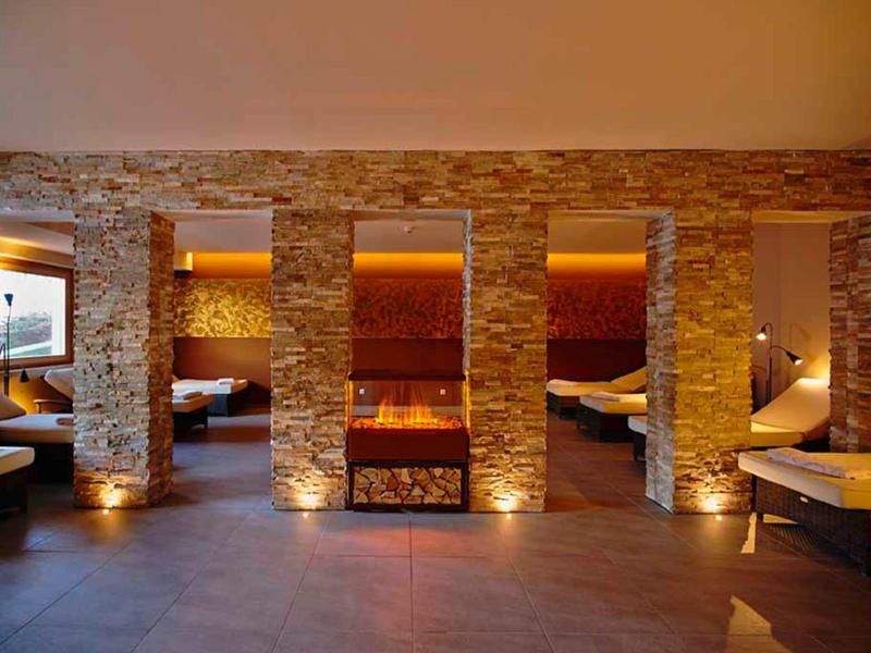 Cozy spa area with warm lighting and stone walls