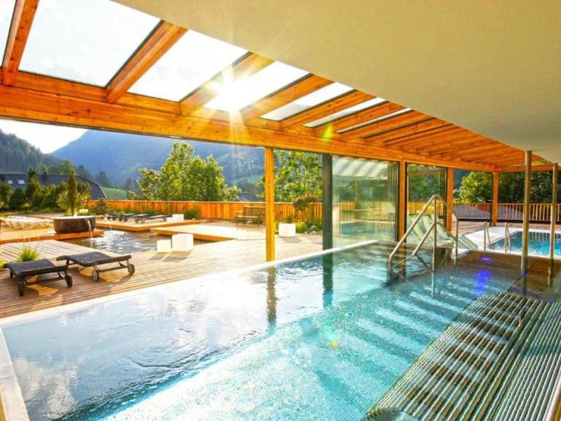 Luxury indoor and outdoor pool with panoramic mountain and sun views