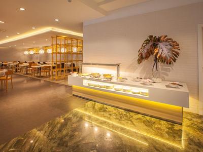 Modern hotel restaurant with elegantly lit buffet and stylish interior design.