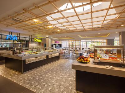 Modern hotel buffet with ample natural light and a variety of dishes.
