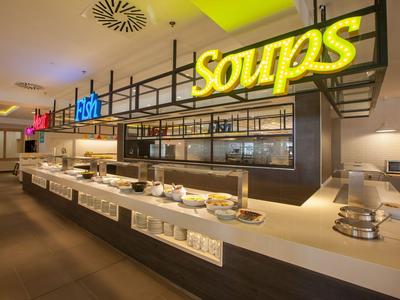 Buffet with various food stations in a modern restaurant.