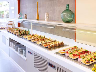 Buffet with various appetizers on plates in a bright room