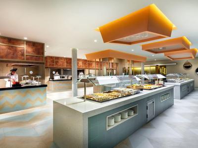 Modern buffet restaurant with diverse food selection and bright, spacious atmosphere.
