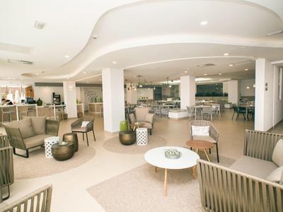 Spacious, bright hotel lobby with modern seating and neutral decor.
