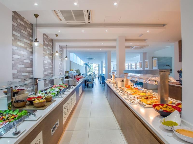 Buffet area in a modern hotel with a wide variety of dishes on both sides.