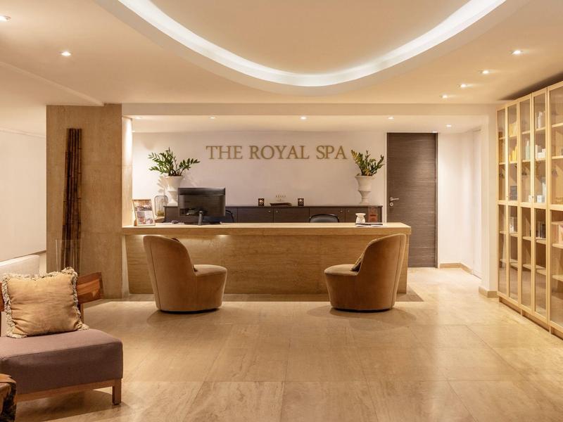 Reception of an elegant spa area with comfortable chairs and warm lighting.