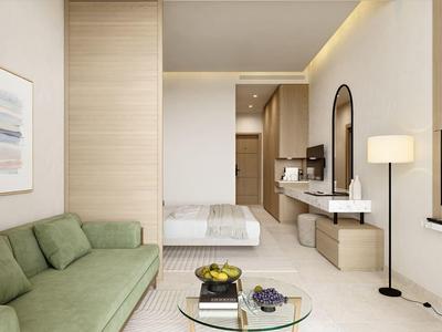 Modern hotelkamer met groene bank, glazen salontafel en comfortabel bed in neutrale tinten.