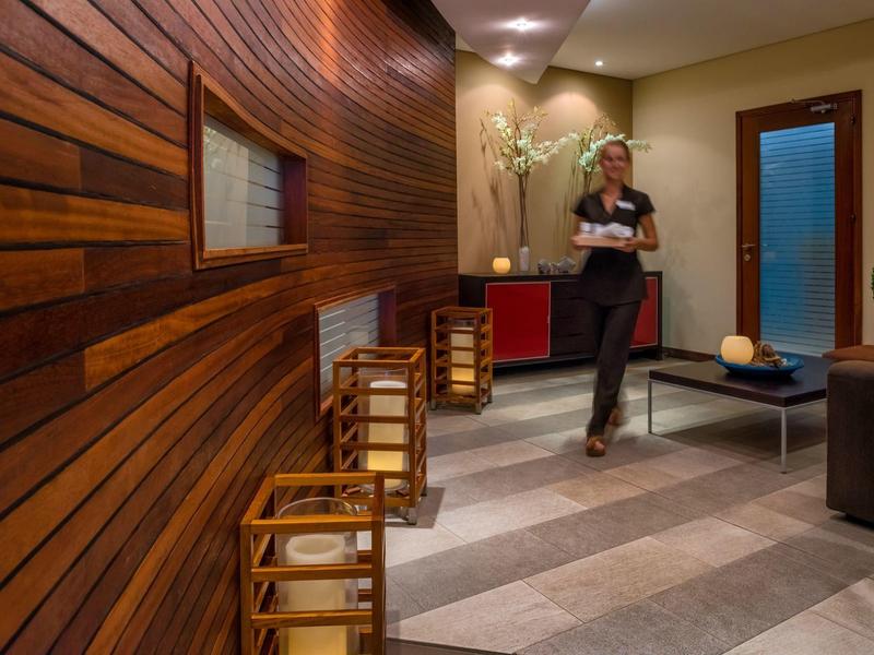 Modern hotel lounge area with wood paneling and cozy lighting.