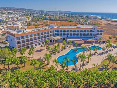 Großes Hotel mit geschwungenem Pool, Palmen und Blick auf das Meer und die Stadt.