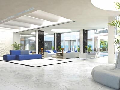 Área de vestíbulo de hotel moderno con mobiliario minimalista y grandes ventanas.