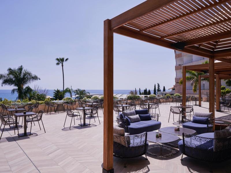 Terrace with seating areas and sea view on a sunny day