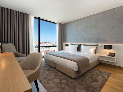 Modern hotel bar with wooden floors, bar stools, and cozy seating areas in daylight