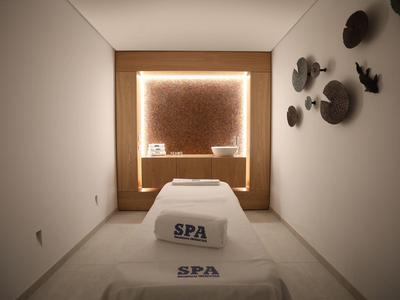 Bright spa room with loungers and ambient wall lighting