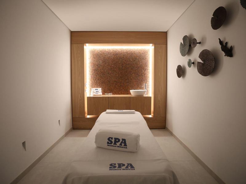 Bright spa room with loungers and ambient wall lighting