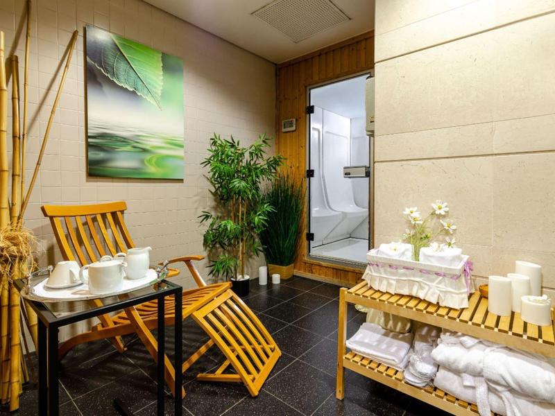 Cozy spa area with wooden furniture, fresh towels, and a calm atmosphere.