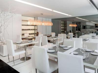 Modern eingerichteter Hotelrestaurantbereich mit weißen Möbeln und minimalistischem Design.