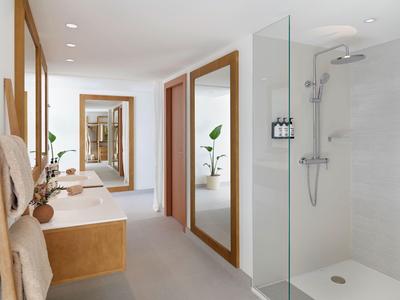Bagno moderno e luminoso con doppi lavabi, doccia in vetro e grandi specchi.
