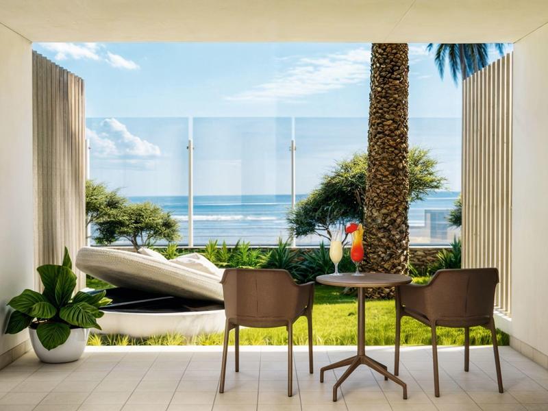 View of the sea from a covered terrace with table, two chairs, and plants.
