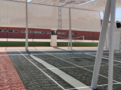 Covered tennis court with net and adjacent red sports court under clear sky.