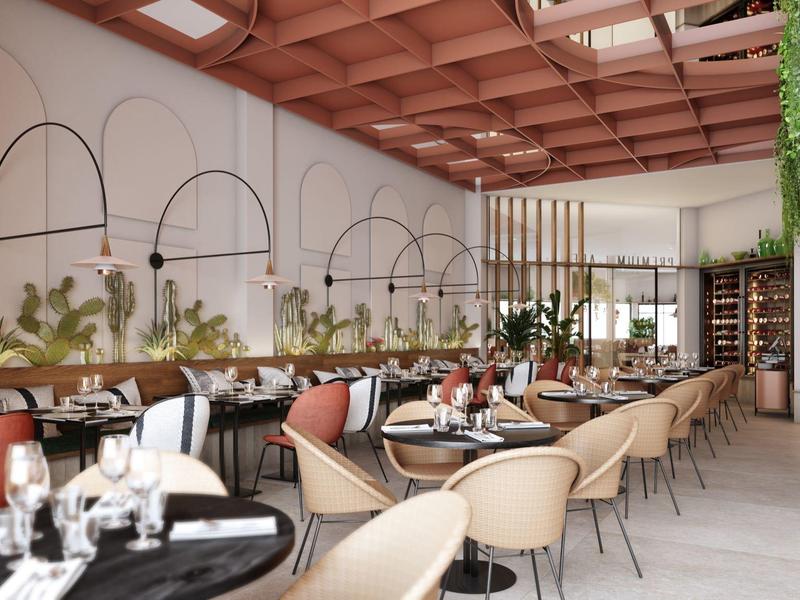 Modern restaurant with comfortable chairs, tables, and warm lighting under a wooden ceiling.