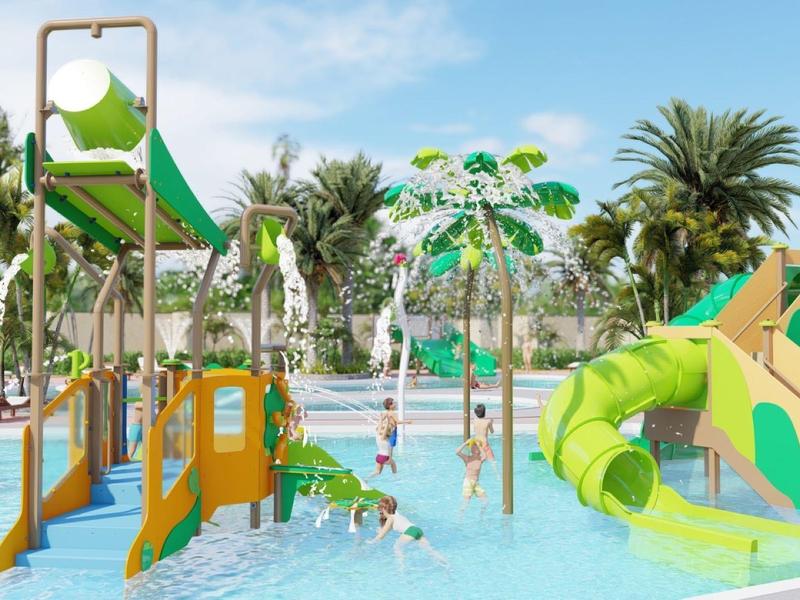 Colorful water playground with slides and spray features around a shallow pool.