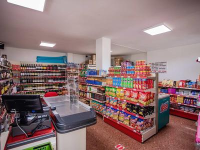 Interior of a small store with shelves filled with snacks and drinks in a hotel