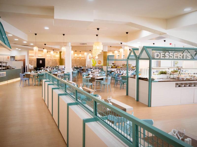 Ampia sala da pranzo con buffet e angolo dessert in un hotel