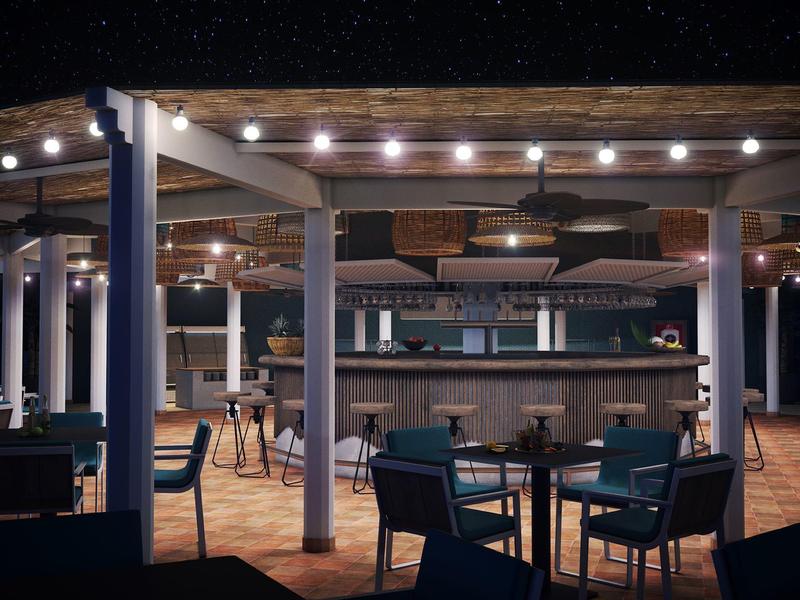 Bar accogliente con sedute di stile e luci calde in uno spazio aperto.