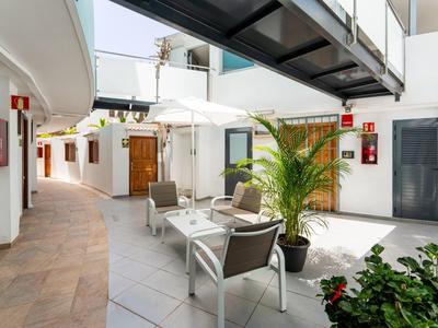 Modern hotel lobby with seating, plants, and open light design.