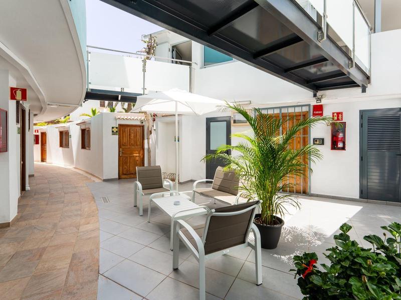 Modern hotel lobby with seating, plants, and open light design.