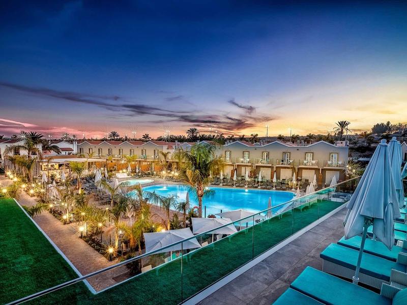 Nowoczesny basen hotelowy z wygodnymi leżakami o zachodzie słońca