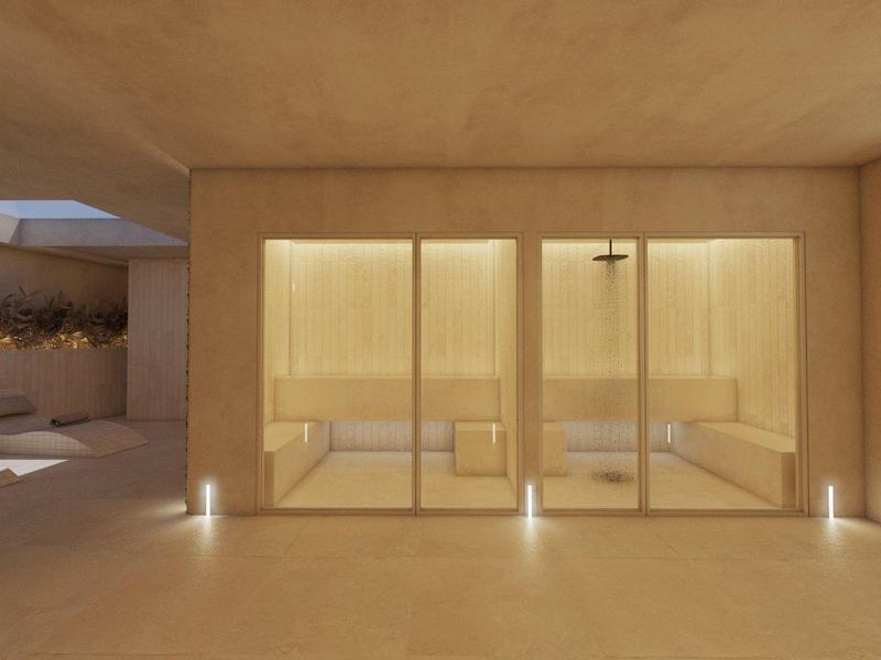 Moderne spa ruimte met verwarmde ligstoelen in een warm verlichte omgeving.