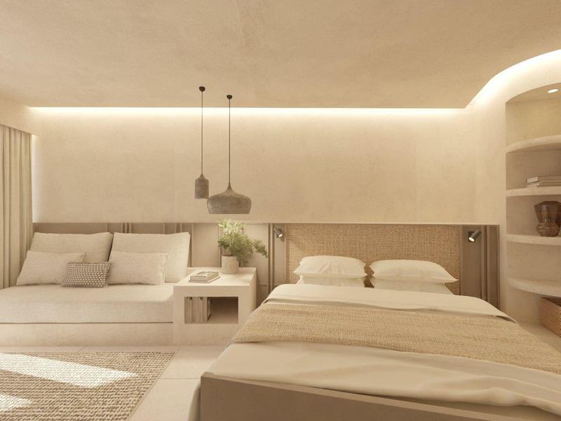 Lichte, moderne slaapkamer met twee bedden, stijlvolle nachtkastjes en ingebouwde planken.