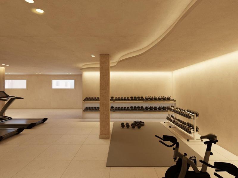 Moderne fitnessruimte met loopbanden, halters en hometrainer, minimalistisch ingericht.