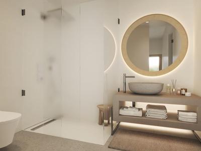 Moderne badkamer met inloopdouche, wandtoilet en verlichte ronde spiegel.