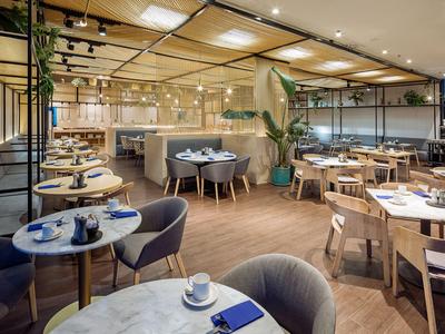 Elegantes Restaurant mit modernen Tischen, Stühlen und stilvoller Beleuchtung