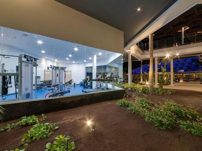 Modern gym with glass walls and outdoor area at dusk