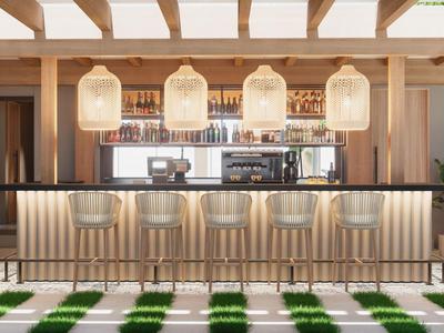 Espace bar moderne avec des chaises claires et des lampes élégantes dans un hôtel