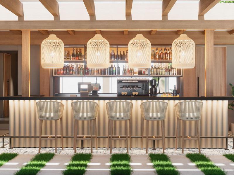 Espace bar moderne avec des chaises claires et des lampes élégantes dans un hôtel