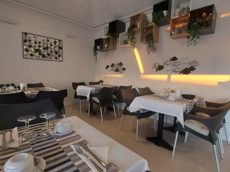 Modern dining room with set tables and ambient wall lighting